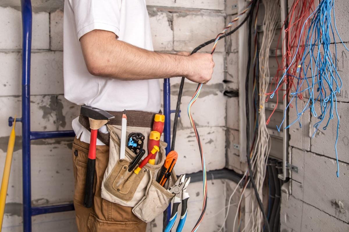 electrician-working-near-board-with-wires-installation-connection-electrics